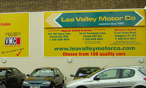 Hoarding sign installed, including built up aluminium tray at top